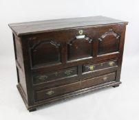 An 18th century oak mule chest, the front with triple fielded panels above two short and a single