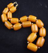 A Middle Eastern? amber and gold bead necklace, the amber beads of graduated rounded rectangular