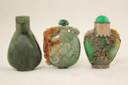 Two Chinese jadeite snuff bottles and a spinach green jade snuff bottle, 20th century, the first