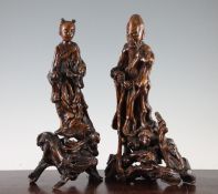 A pair of Chinese rootwood carvings of immortals, 19th century, each on rootwood stands, 35cm. and