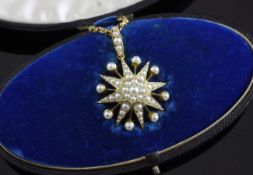 A late Victorian gold and split pearl starburst pendant, on a fine link chain, in Goldsmiths &