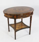 An oval mahogany centre table, the top inlaid with central paterae and flowerhead border, with