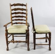 A set of six Country ladderback dining chairs, two with arms, four singles, with rush seats, on