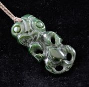 A Maori carved jade tiki pendant, the back inscribed EP, 2.75in.