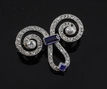 A French Belle Epoque 18ct white gold, sapphire and diamond brooch, of stylised scroll design, set