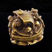 A Japanese stained ivory okimono netsuke of the Takarabune, early 20th century, carved with the