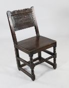 A late 17th century oak side chair, with carved and panelled back, on bobbin turned supportsFrom a
