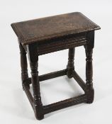 A 17th century oak joynt stool, with rectangular pegged top and channel moulded frieze, on ring