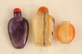 Two Chinese banded chalcedony snuff bottles and an amethyst quartz snuff bottle, 19th / 20th