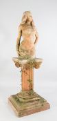A large terracotta garden figure of Cleopatra, on an ionic fluted column with square stepped base,
