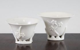 Two Chinese blanc-de-chine libation cups, Dehua, 18th century, each moulded with prunus sprigs on