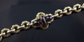 A Victorian gold and cabochon foil backed garnet set bracelet, with facetted and engraved links, 7.