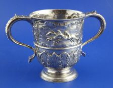 A George II silver loving cup, embossed with a horse racing scene above a band of acanthus leaves,
