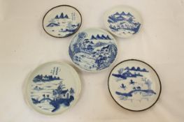 Five Chinese blue and white saucer dishes, 19th century, each painted with figures in river