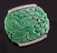 A white gold, diamond and jade brooch, the central plaque carved with fruit and a large leaf within