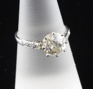 A 1920`s platinum and solitaire diamond ring, with diamond set shoulders, the round cut stone