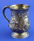 A George I silver baluster mug, with later embossed decoration and engraved monogram, RA?, London,