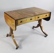An early 19th century rosewood and crossbanded sofa table, with two drawers opposing two dummy