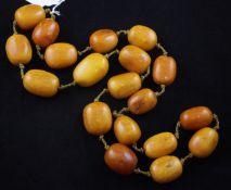 A single strand oval amber bead necklace, gross 255 grams, 37in.