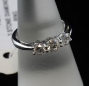 A white gold and three stone diamond ring, with an estimated total diamond weight of 1.00ct, size