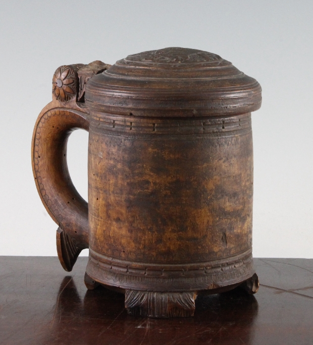 A 19th century Norwegian birch peg tankard, with hinged domed lids, 7.25in., faults