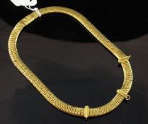 A gold articulated snake link necklace, with three hooked bands (lacking drops?) and foliate
