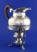 A late Victorian Regency style silver hot water pot and burner stand, with tongue and dart borders,