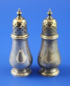 A pair of early 20th century Tiffany & Co sterling silver pepperettes, of baluster form, with