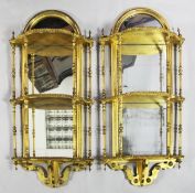 A pair of 19th century arched giltwood wall brackets, with mirror backs and three serpentine