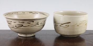 An Annamese underglaze black bowl and a similar cup, 14th century, the bowl decorated with scroll