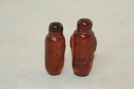 Two Chinese amber snuff bottles, 1800-1900, the first carved as fruits including pomegranate,