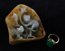 A Chinese jadeite small boulder carving and a green jadeite cabochon ring, the boulder carved in