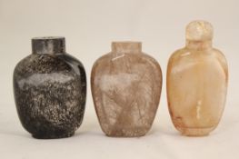 Three Chinese hair crystal snuff bottles, 1760-1880, the first clear with silver tourmaline