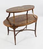 An Edwardian Adams style oval mahogany marquetry inlaid two tier etagere, decorated with musical