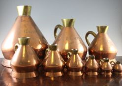 A set of nine copper and brass conical capacity measures, 2 gallons to quarter gill, marked for