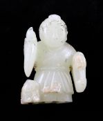 A Chinese pale celadon jade figure, standing one hand aloft with a lion-dog by his side, pierced to