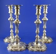 A set of four Victorian silver plated candlesticks, with engraved armorial and waisted knopped