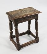 A 17th century oak joynt stool, with rectangular pegged top, the frieze carved with floral