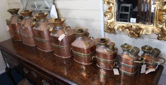 A collection of eight graduated copper and brass check pump measures, 5 gallons to 1 pint, engraved