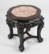 A low Chinese urn stand, with inset octofoil rouge marble top, traditional pierced and carved