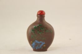 A Chinese enamelled Yixing pottery snuff bottle, decorated with bamboo and rockwork, 6.2cm.