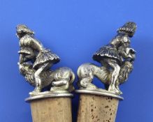 A pair of late 19th/early 20th century continental silver figural mounted cork decanter stoppers,