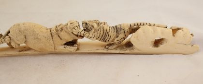 A Japanese walrus tusk carving, early 20th century depicting tigers attacking hippos, 17in.