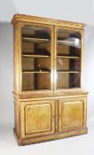 A Victorian light oak bookcase, with two glazed doors over two cupboard doors, with pollard oak
