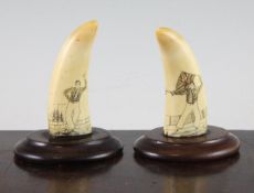 A pair of small scrimshaw whale`s teeth, depicting sailors, mounted on oval bases