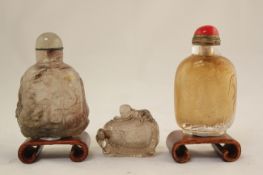 Two Chinese rock crystal snuff bottles and a clear glass snuff bottle, 19th / 20th century, the