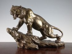 A large Japanese bronze figure of a tiger on a rockwork base, Meiji period, the roaring tiger