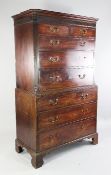 A George III mahogany chest on chest, fitted two short and three long drawers between reeded sides,
