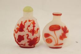 Six Chinese red overlaid snuff bottles, 19th / 20th century, three with clear grounds, the first