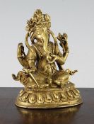 A Nepalese gilt bronze seated figure of Ganesh, 19th / early 20th century, seated on a lotus